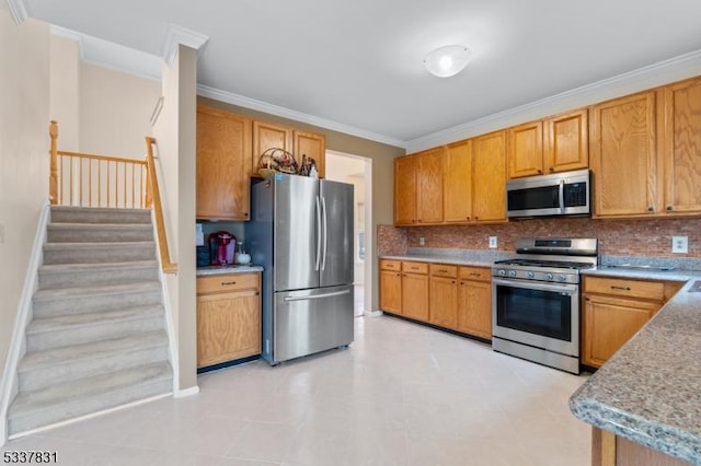 kitchen with crown molding, decorative backsplash, stainless steel appliances, and light countertops