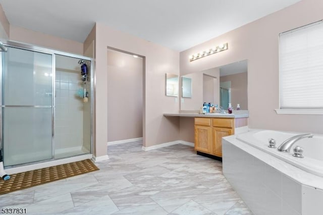 bathroom with vanity, a shower stall, a bath, and baseboards