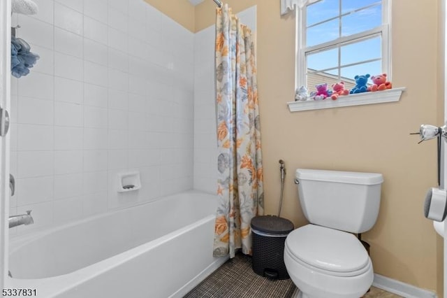 bathroom featuring toilet, baseboards, shower / tub combo with curtain, and tile patterned floors