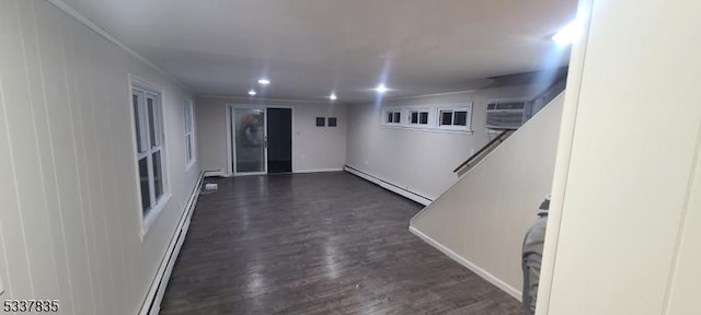 unfurnished room with dark wood-style floors, crown molding, recessed lighting, a baseboard heating unit, and an AC wall unit