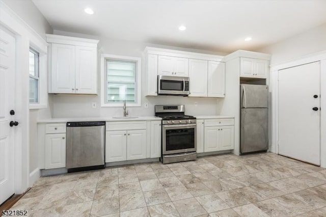 kitchen featuring white cabinetry, appliances with stainless steel finishes, and sink