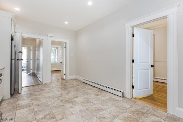 empty room featuring a baseboard heating unit