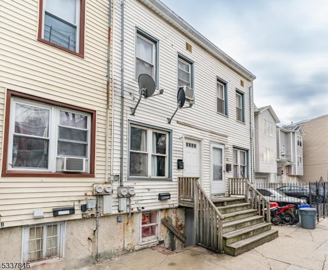 rear view of property featuring a patio and cooling unit