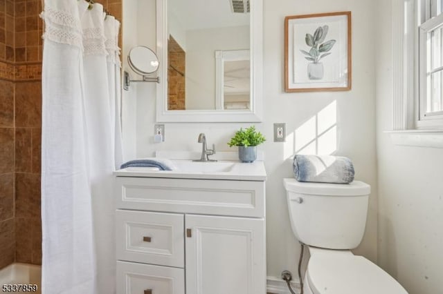 full bath with toilet, visible vents, and vanity