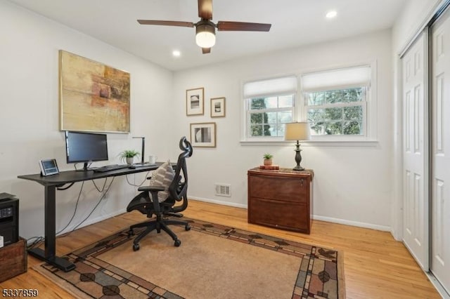 office area with recessed lighting, visible vents, light wood-style floors, a ceiling fan, and baseboards