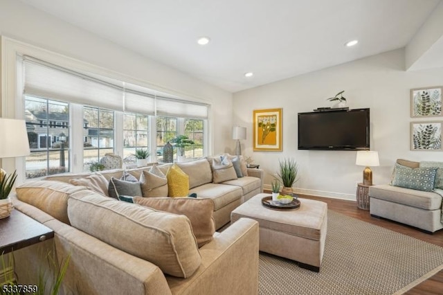 living room with lofted ceiling, baseboards, wood finished floors, and recessed lighting