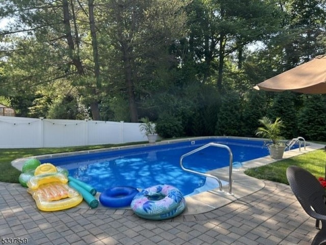 view of pool with a fenced in pool, a patio area, and fence