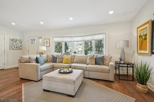 living room featuring recessed lighting, baseboards, and wood finished floors