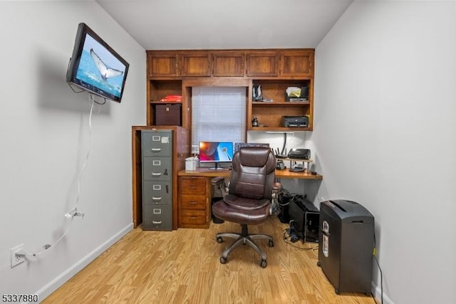 office featuring baseboards and light wood-style floors