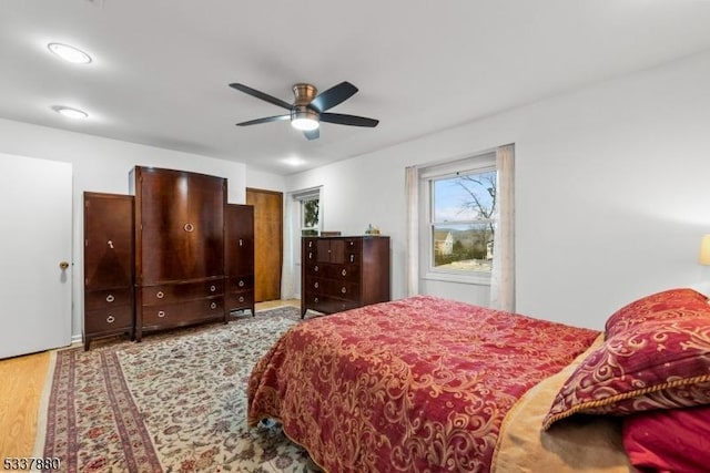 bedroom with a ceiling fan and wood finished floors