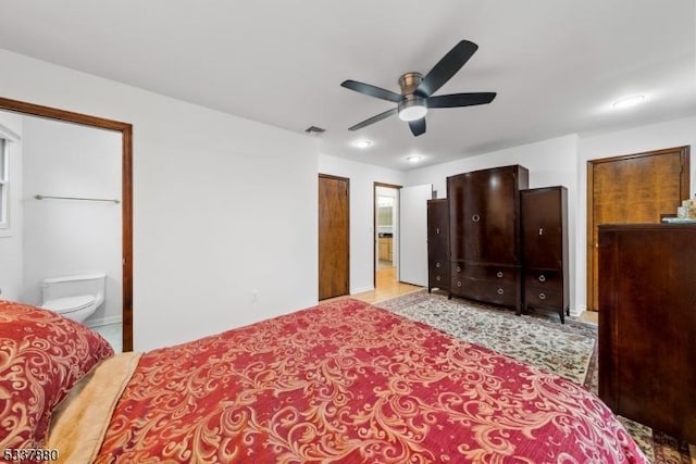 bedroom with ceiling fan, visible vents, and ensuite bathroom