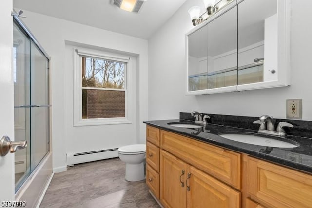 bathroom with toilet, a baseboard radiator, visible vents, and a sink