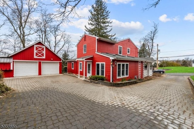 view of property exterior with a garage and an outbuilding