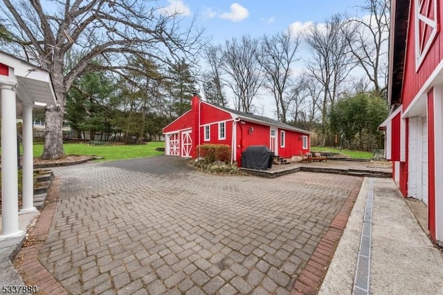 view of side of property featuring a barn and an outdoor structure