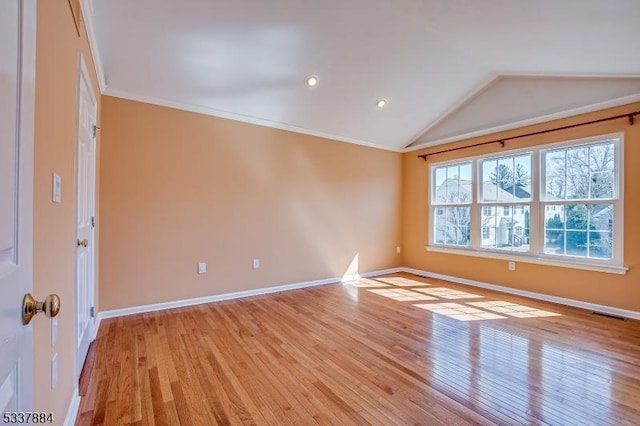 unfurnished room featuring lofted ceiling, light wood-style floors, baseboards, and ornamental molding