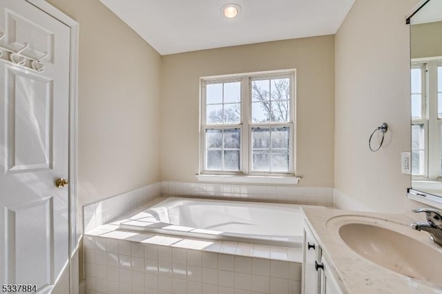 full bathroom featuring vanity and a garden tub