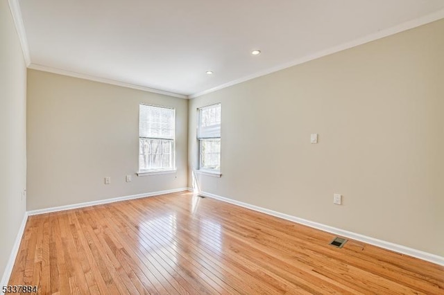 unfurnished room featuring recessed lighting, light wood-style floors, baseboards, and ornamental molding