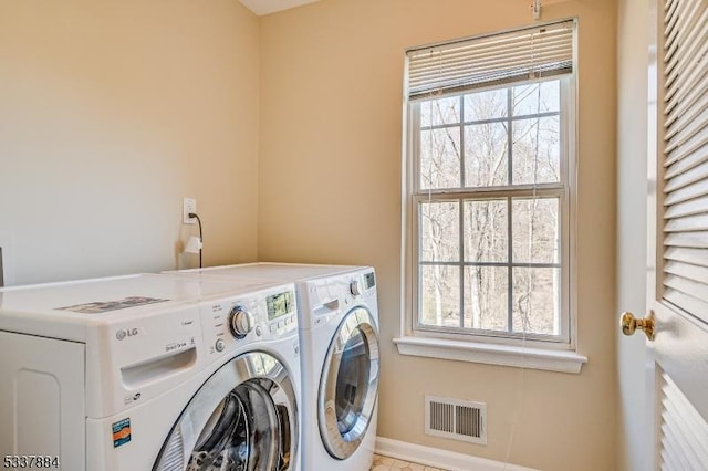 laundry area featuring washer and dryer, visible vents, and laundry area