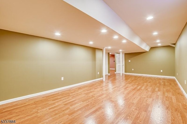 finished basement featuring recessed lighting, baseboards, and light wood finished floors