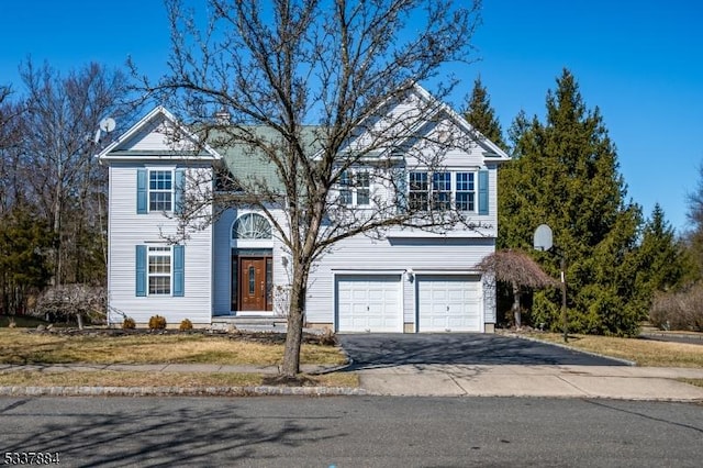 view of front of home featuring aphalt driveway and a garage