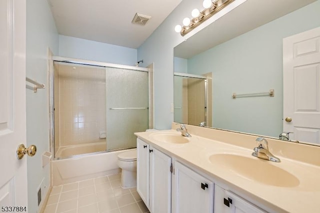 bathroom with tile patterned floors, toilet, visible vents, and a sink