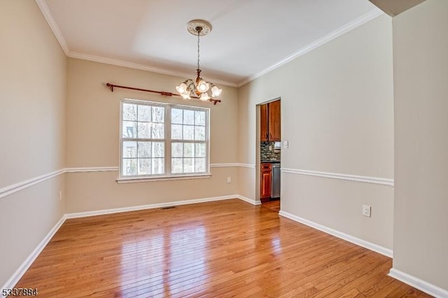 empty room with light wood-type flooring, baseboards, an inviting chandelier, and ornamental molding