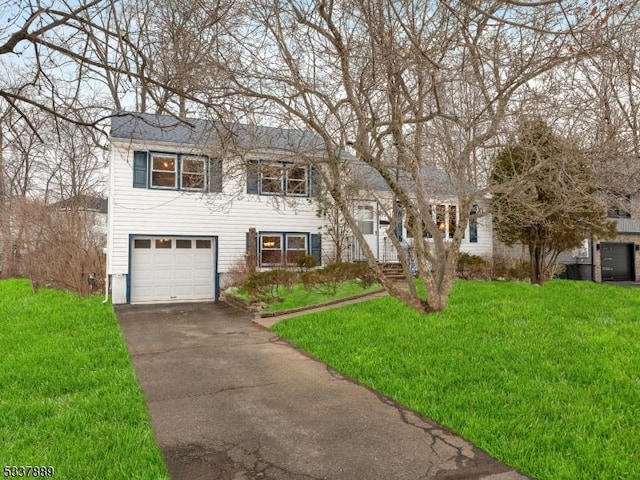 bi-level home with a garage and a front yard