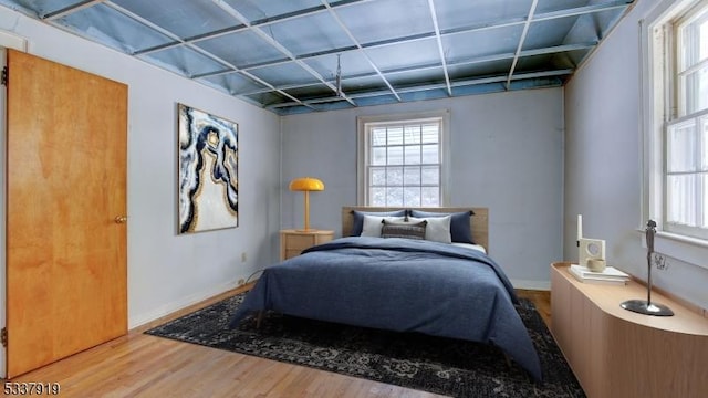 bedroom featuring hardwood / wood-style flooring and multiple windows