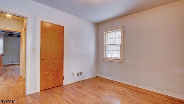 spare room featuring light hardwood / wood-style floors