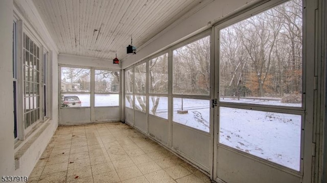 unfurnished sunroom with wood ceiling