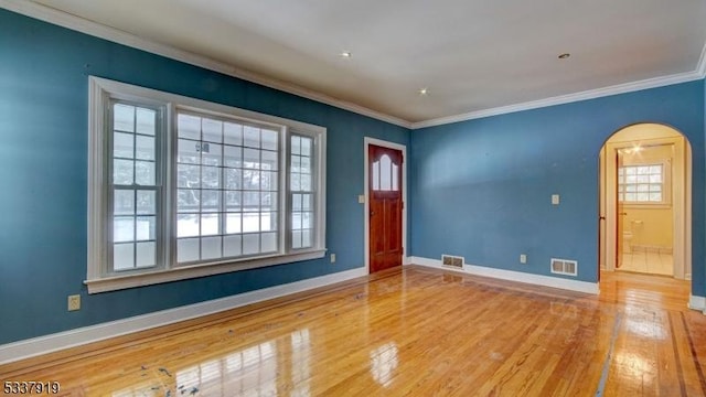 unfurnished room with crown molding and light hardwood / wood-style floors