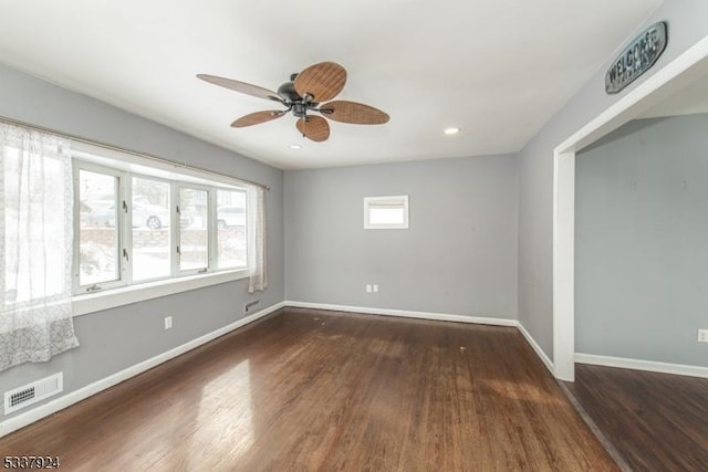 unfurnished room with ceiling fan and dark hardwood / wood-style flooring