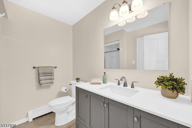 bathroom featuring a baseboard radiator, vanity, toilet, and tile patterned floors