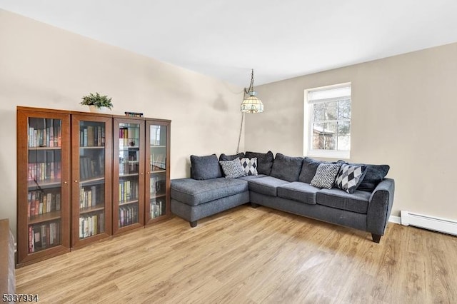 living room with baseboard heating and light hardwood / wood-style floors