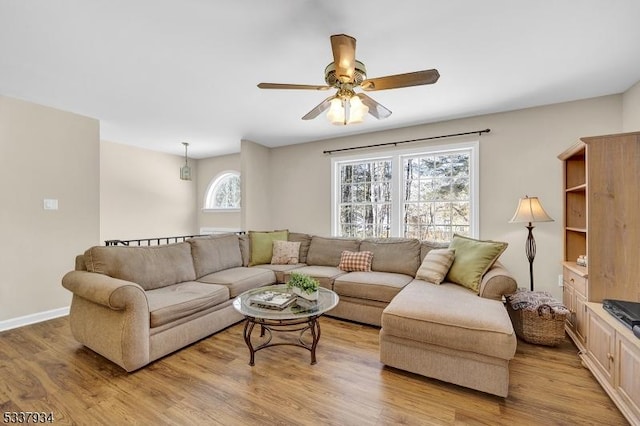 living room with ceiling fan and light wood-type flooring