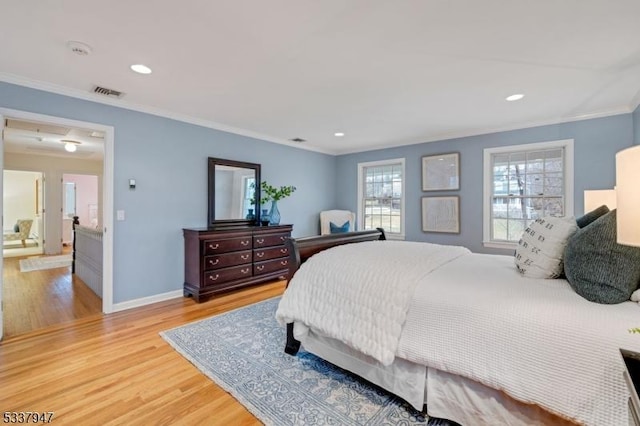 bedroom featuring baseboards, visible vents, ornamental molding, light wood-type flooring, and recessed lighting