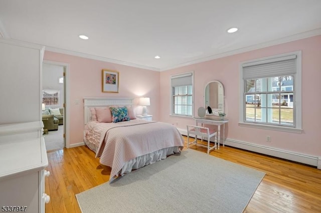 bedroom featuring crown molding, recessed lighting, light wood-style flooring, a baseboard heating unit, and baseboards