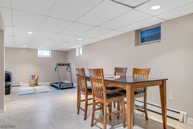 dining space featuring recessed lighting, a baseboard radiator, a paneled ceiling, and baseboards