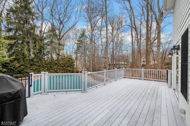 wooden terrace featuring grilling area