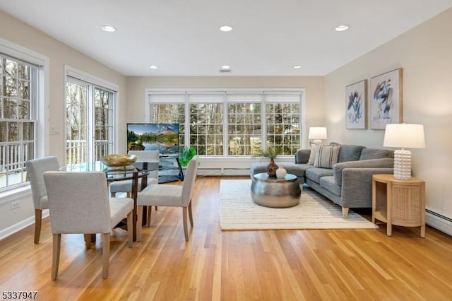 interior space featuring recessed lighting, baseboards, and light wood finished floors