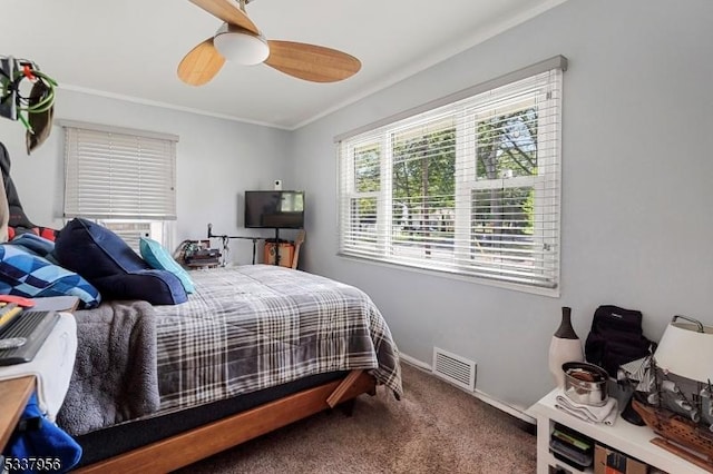 bedroom with crown molding, carpet floors, and ceiling fan