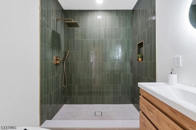 full bath featuring a walk in shower and vanity