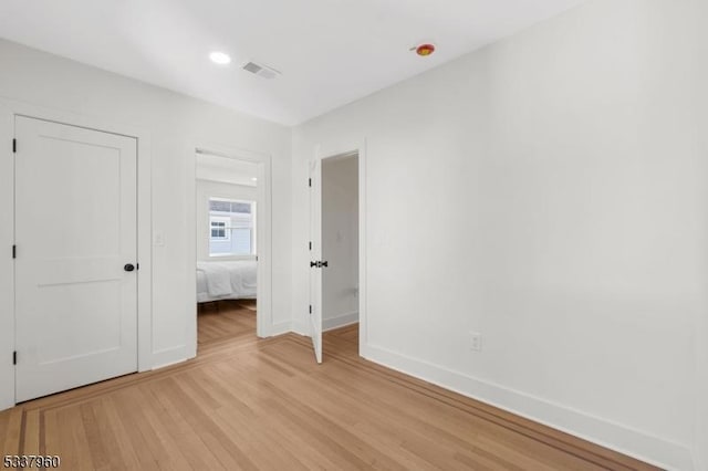 unfurnished bedroom with recessed lighting, visible vents, light wood-style flooring, and baseboards