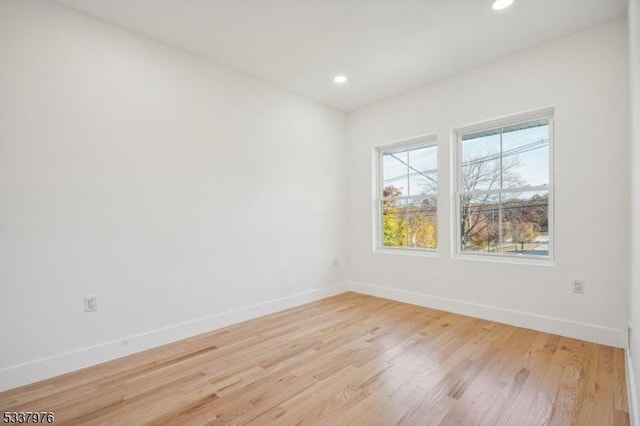 spare room featuring light wood-type flooring