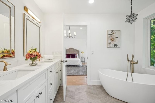 bathroom featuring vanity and a tub