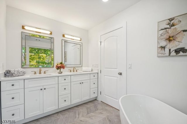 bathroom featuring vanity and a bath