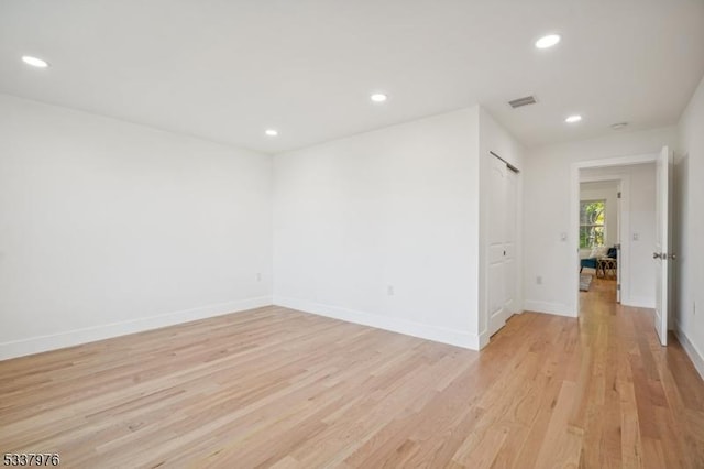 empty room with light hardwood / wood-style floors