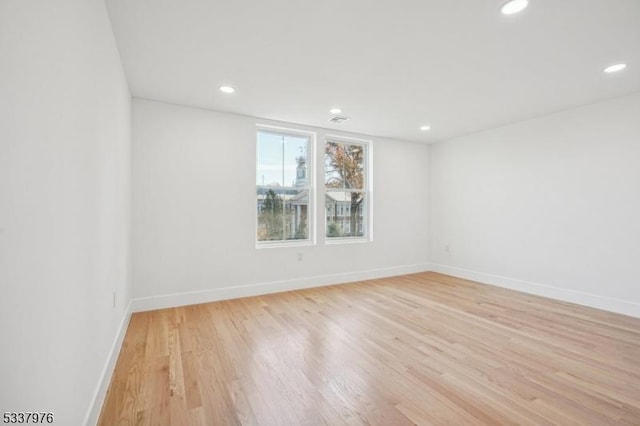 empty room with light hardwood / wood-style flooring