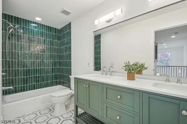 full bathroom with vanity, toilet, and tiled shower / bath combo