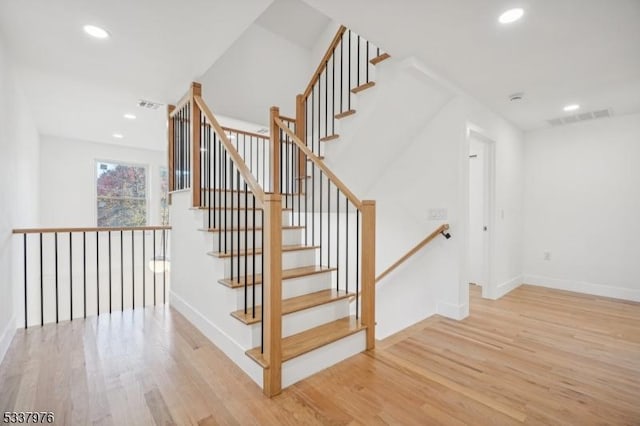 stairs featuring hardwood / wood-style flooring